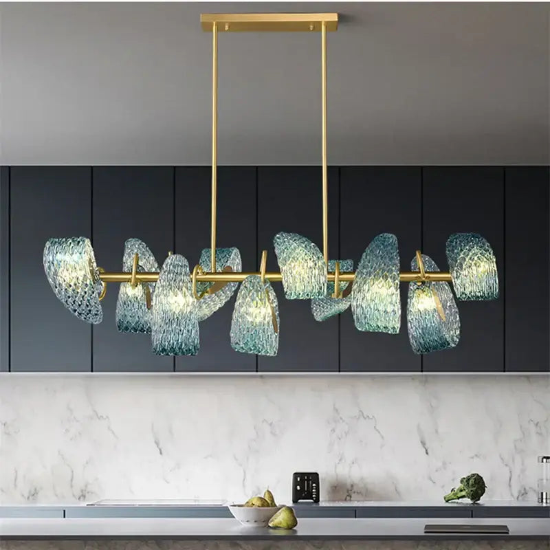 A modern pendant lamp with gold metal frame and decorbites blue glass led shades for bedroom chandelier lighting