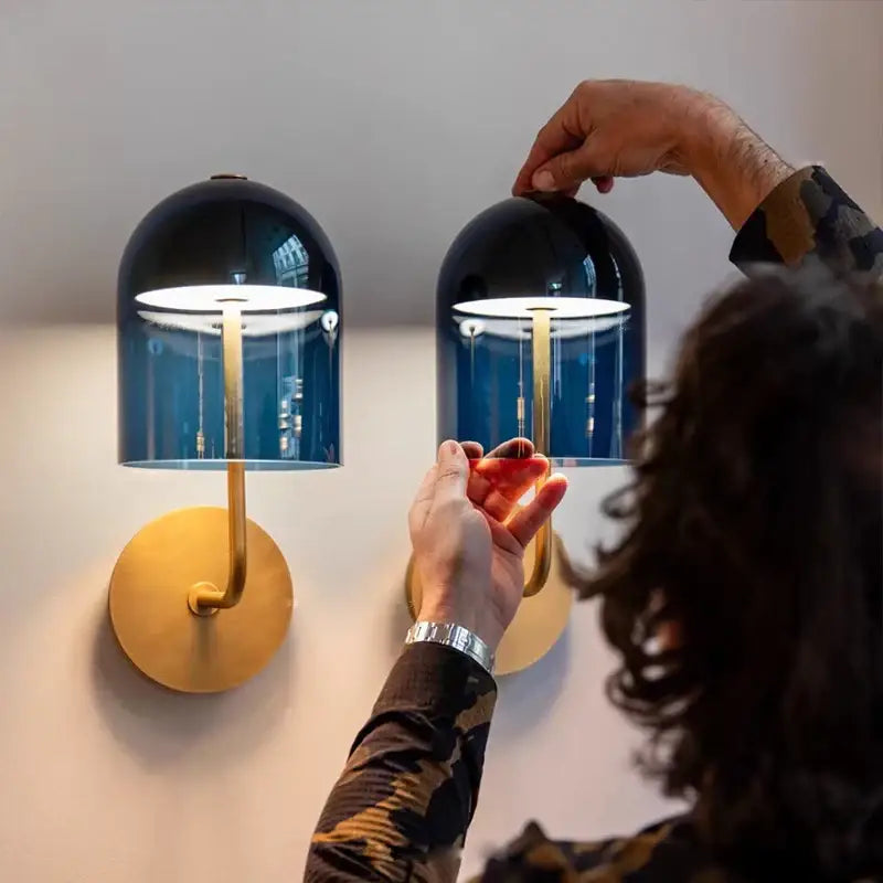 Modern blue glass wall lamp pair with gold-toned brass bases and stems for bedroom decorbites blue glass wall lighting