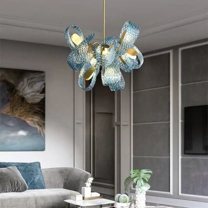 A modern blue decorbites glass chandelier with woven petal design and gold-toned accents for dining room lighting
