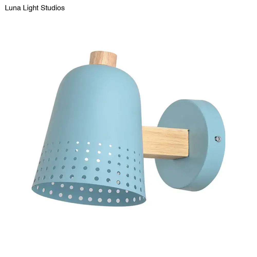 Modern blue metallic bell wall sconce with perforated light cone shade and wooden accents for restaurant lighting