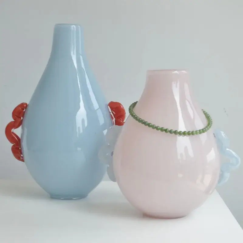 Pastel blue and pink glass geometric flower vases with sculpted red and light blue handles for modern living room decor