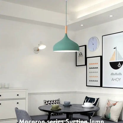 Teal pendant light with wood accent at the top helps create a modern look for kitchen lighting