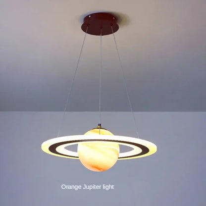 Modern blue planet pendant light with rings featuring a warm orange decorbites acrylic planet orb for bedroom decor