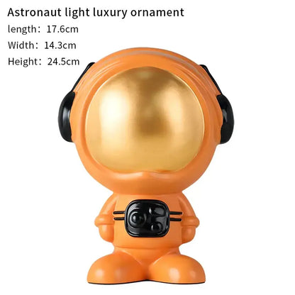 Modern blue and red gradient decorbites astronaut statue with glossy orange body and shiny gold helmet for living room decor