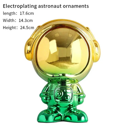 Modern blue and red gradient decorbites astronaut statue featuring shiny gold and green electroplated suit and reflective helmet