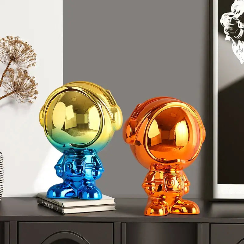 Two glossy decorbites astronaut statue figurines with blue red and gold orange gradient colors for living room decor