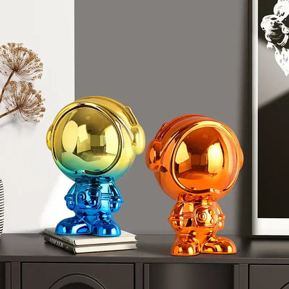 Two glossy decorbites astronaut statue figurines with blue red and gold orange gradient colors for living room decor