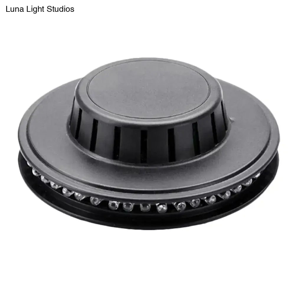 Black circular led ufo karaoke bar wall light with central vented cap and perimeter clear leds for bedroom use