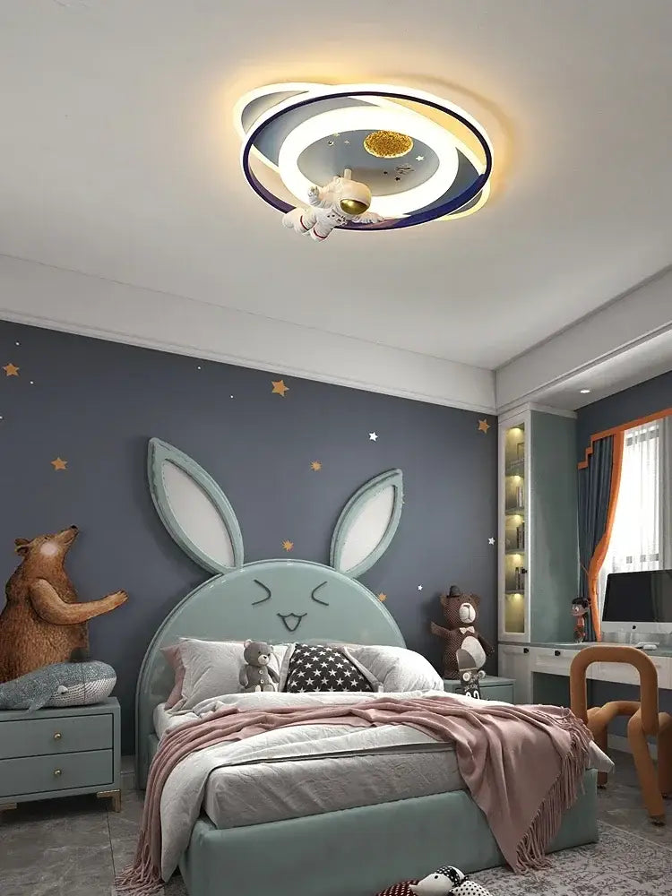Modern blue and white airplane ceiling light with a glowing moon center and decorbites astronaut spaceman figure suspended in space