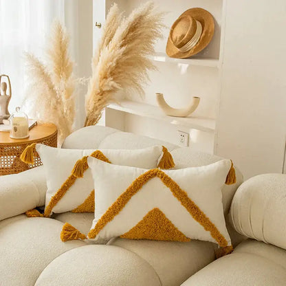 Cream-colored cushion cover with mustard yellow geometric pattern and tassels for decorbites golden yellow living room decor
