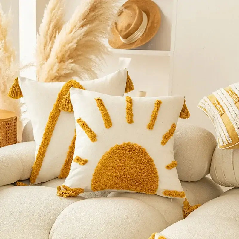 White cushion cover with modern boho mustard sun design made of textured fluffy yarn and tassels decorbites geometric tufted tassel