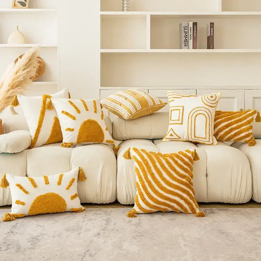 Cream-colored sofa with mustard and white decorbites geometric tufted tassel cushion covers for modern boho decor