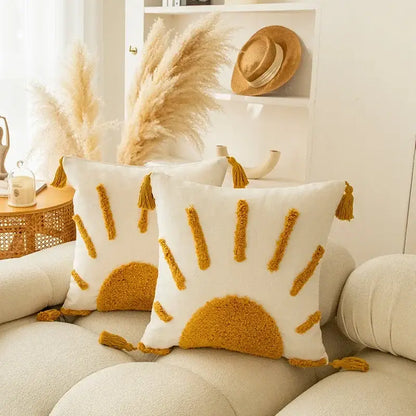 White cushion cover with mustard yellow sunburst embroidery and matching tassels for decorbites geometric tufted tassel decor