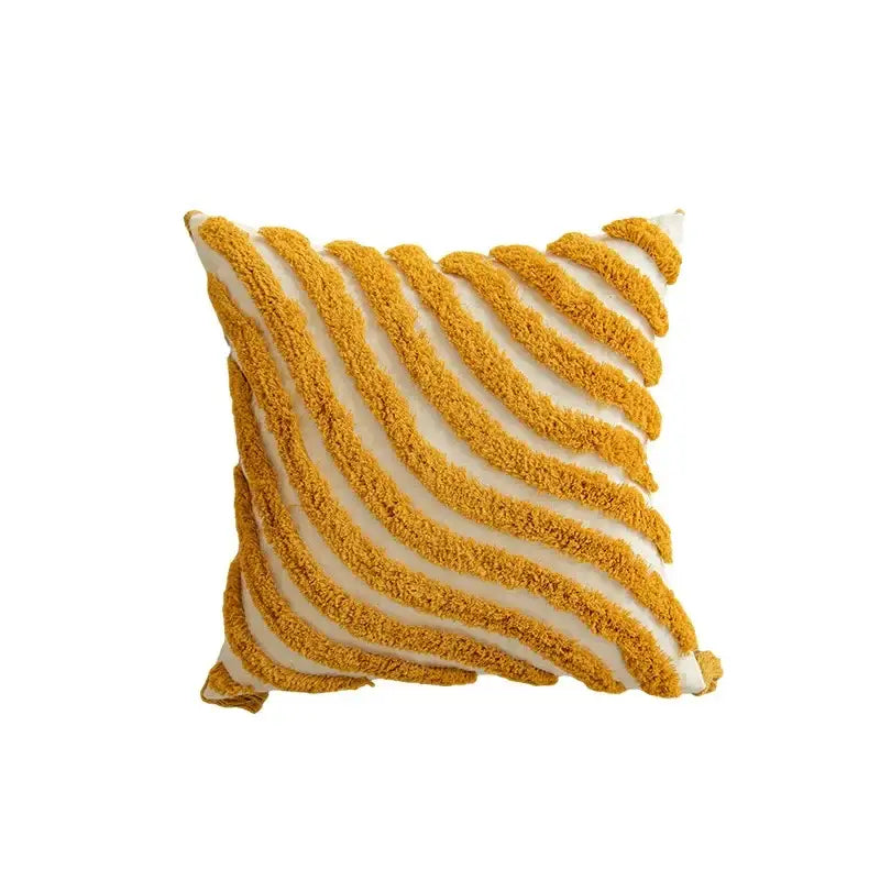A cozy cushion cover with bold mustard yellow and cream geometric tufted tassel stripes in plush woven fabric