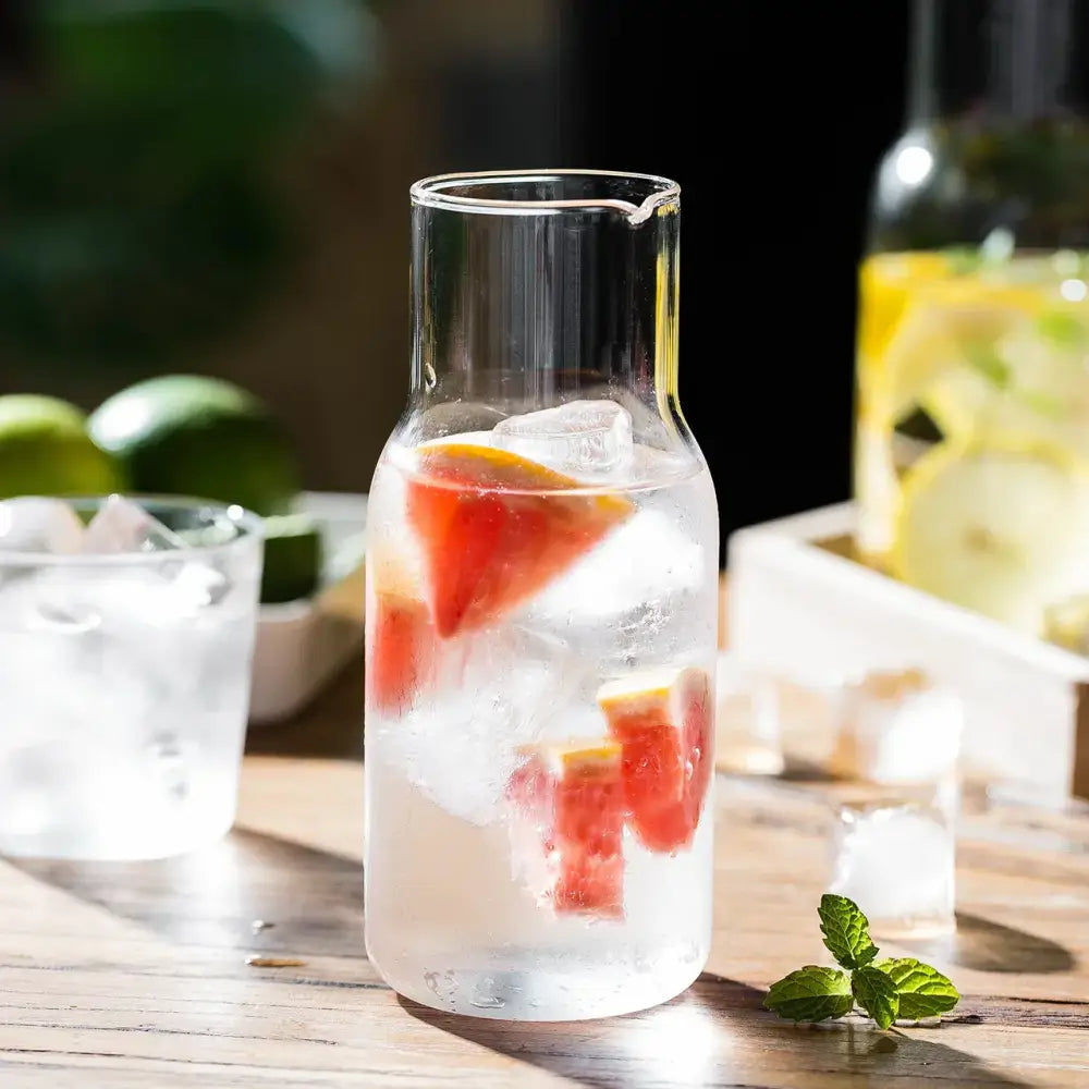 Modern borosilicate glass tea pot filled with ice red fruit and lemon wedges ideal for infusing glass tea