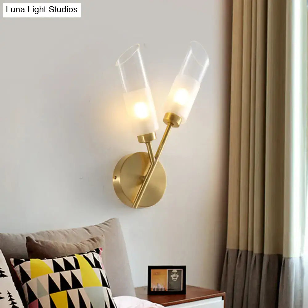 Modern brass 2-light glass wall sconce with gold-toned finish and clear shades emitting warm glow 110v-120v fixture