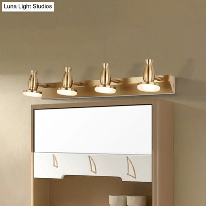 Modern brass bathroom vanity lamp with four adjustable spotlights and round metal shade in gold finish