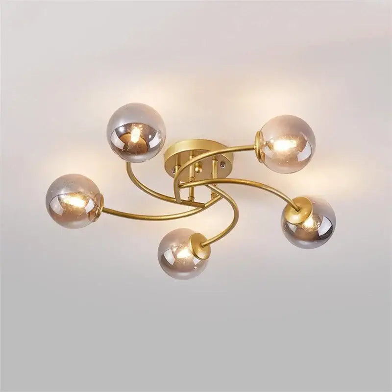 Modern brass 5-light ceiling light fixture with curved arms and frosted glass bulbs for kitchen lighting