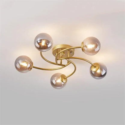 Modern brass 5-light ceiling light fixture with curved arms and frosted glass bulbs for kitchen lighting