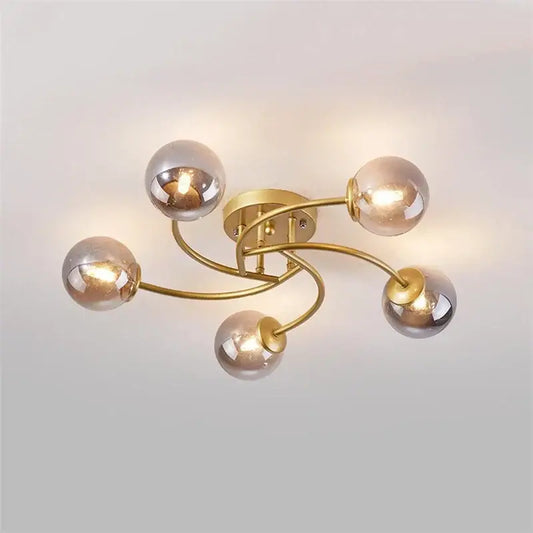 Modern brass 5-light ceiling light fixture with curved arms and frosted glass bulbs for kitchen lighting