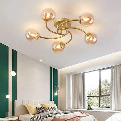 Modern brass 5-light ceiling light fixture with gold-toned curved arms and translucent amber glass bulb for kitchen