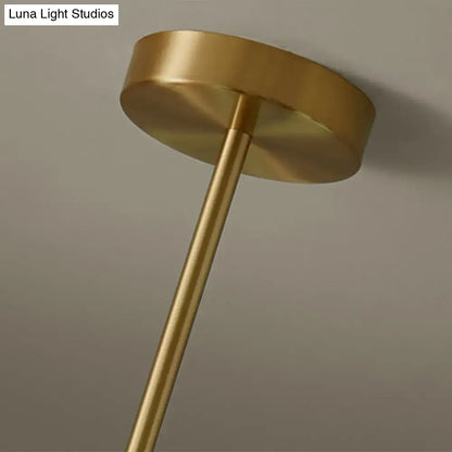 Modern brass 5-light pendant light with gold-finished brass ceiling fixture and spherical glass shade for dining room
