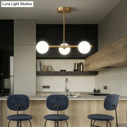 Modern brass 3-light pendant light with spherical glass shade in brass finish for dining room lighting
