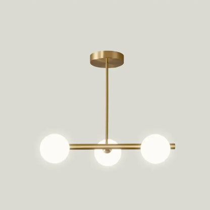 Modern brass pendant light with three frosted spherical glass shade bulbs for dining room lighting