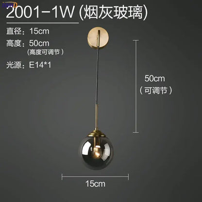 Modern brass and amber decorbites glass ball wall lamp with smoked glass globe and brass finish for bedroom lighting
