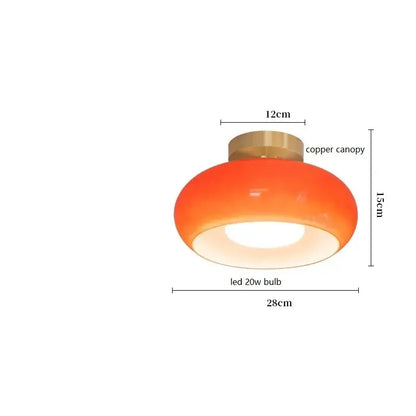 Modern brass and amber glass pendant light with orange dome, copper canopy, and copper bauhaus led bulb for kitchen lighting