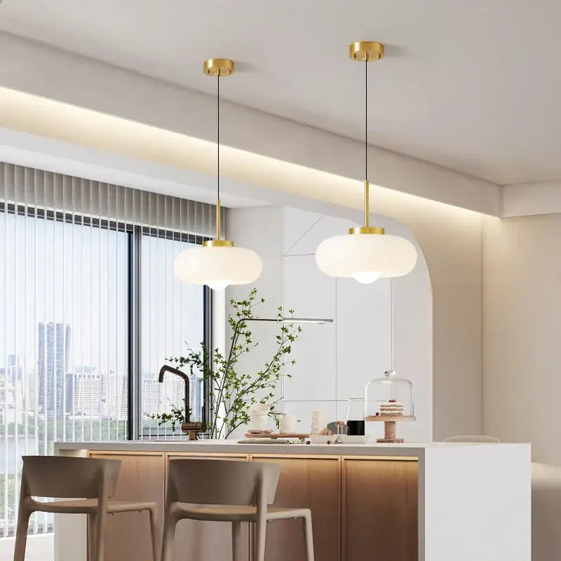 Two modern pendant lights with gold-finished metal fixtures and frosted glass shades for kitchen led lighting decorbites copper bauhaus