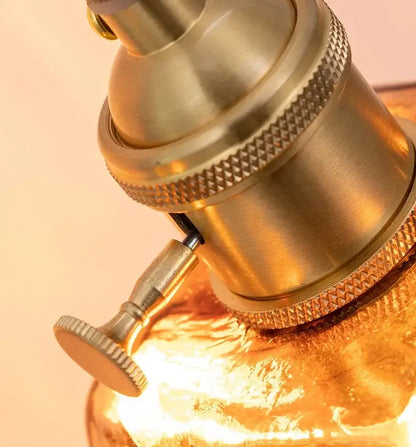 Brass-finished lamp socket with textured knurled rings and adjustment knob for decorbites amber glass wall lamp