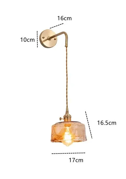 Modern brass wall lamp with decorbites amber glass textured shade and twisted cord for bedroom or living room decor