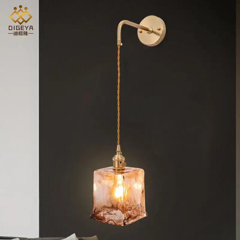 Modern brass and amber glass wall lamp with warm-toned decorbites amber glass cube for bedroom and living room decor
