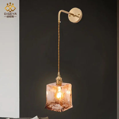 Modern brass and amber glass wall lamp with warm-toned decorbites amber glass cube for bedroom and living room decor
