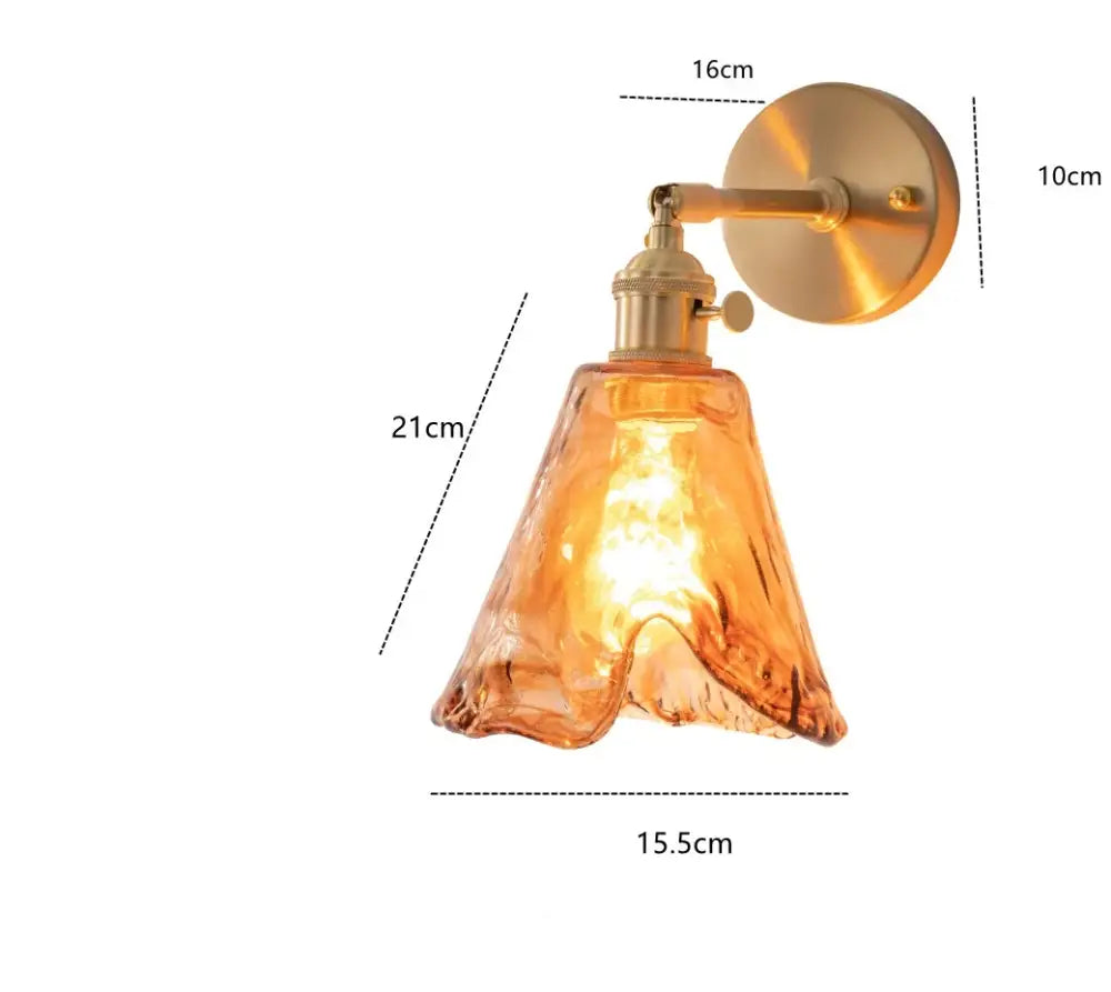 Modern brass and amber glass wall lamp with warm amber glass lampshade and brass-finished metal arm for bedroom decorbites amber glass