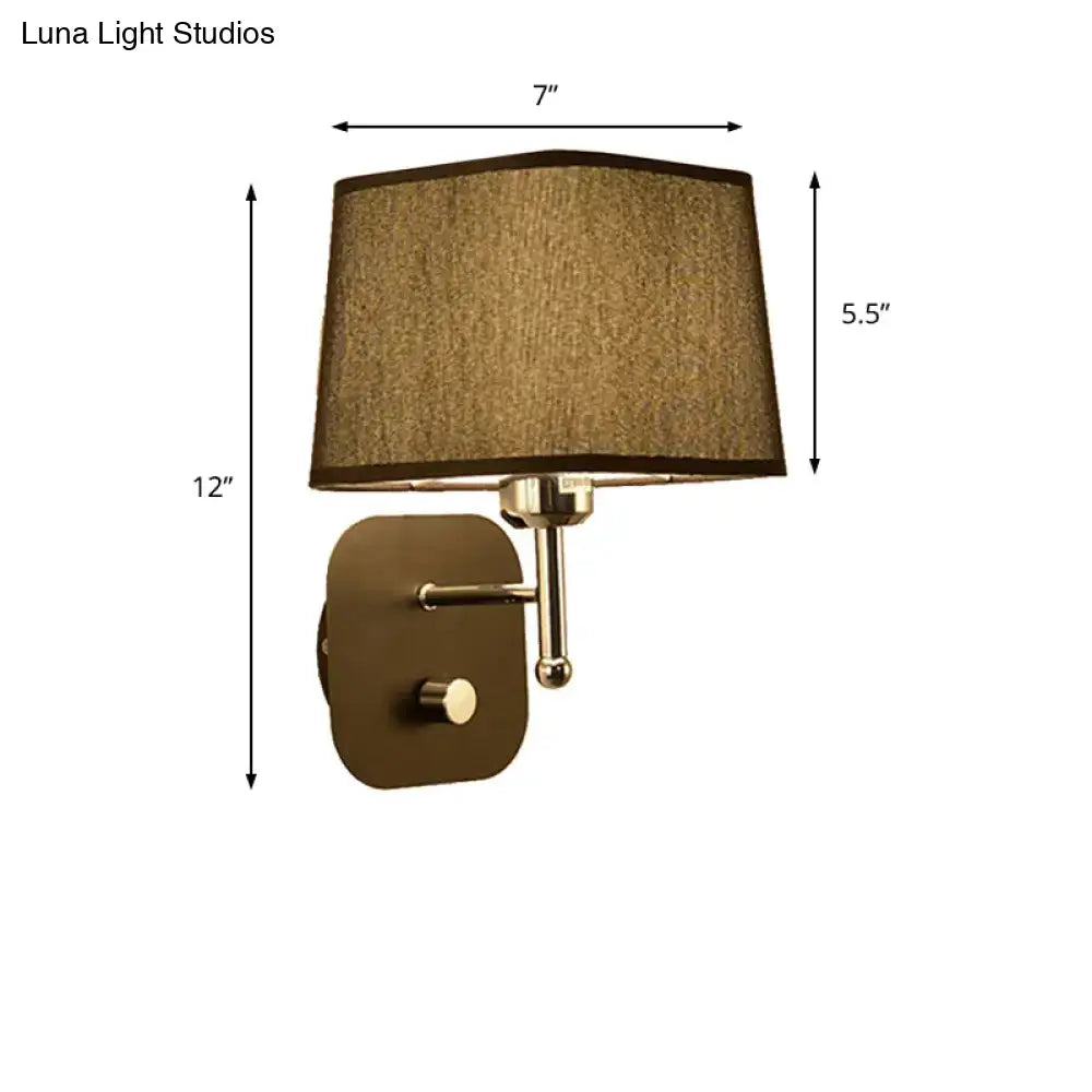 Modern brass and beige linen wall sconce lighting with a taupe fabric shade and polished brass accents for bedroom use