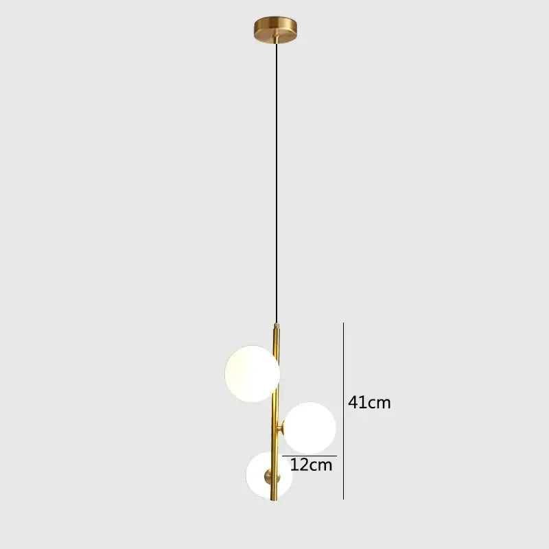 Modern brass and black glass ball pendant light featuring gold-toned fixture with three frosted glass spheres decorbites glass ball