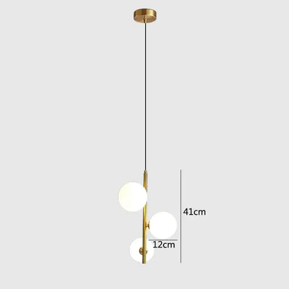 Modern brass and black glass ball pendant light featuring gold-toned fixture with three frosted glass spheres decorbites glass ball