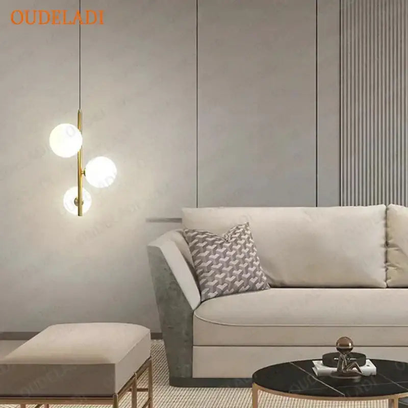 Modern brass and black glass ball pendant light with gold-toned fixture and three spherical glass bulbs for dining room decorbites glass ball