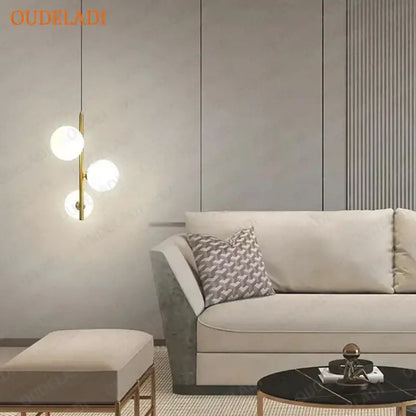 Modern brass and black glass ball pendant light with gold-toned fixture and three spherical glass bulbs for dining room decorbites glass ball