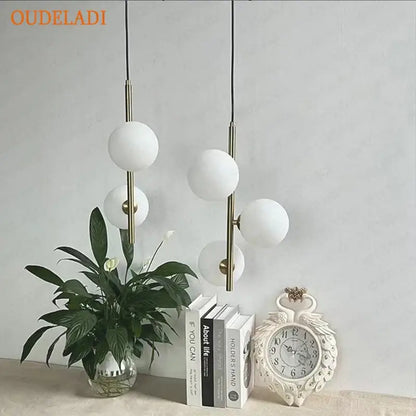 Modern brass and black glass ball pendant light with frosted white globes for dining room decorbites glass ball design