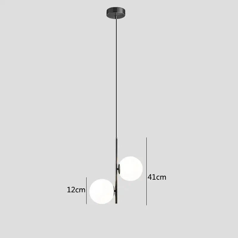 Modern brass and black pendant light with two frosted decorbites glass ball spheres for dining room lighting
