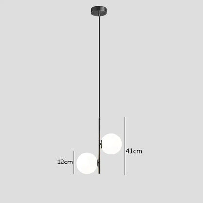 Modern brass and black pendant light with two frosted decorbites glass ball spheres for dining room lighting