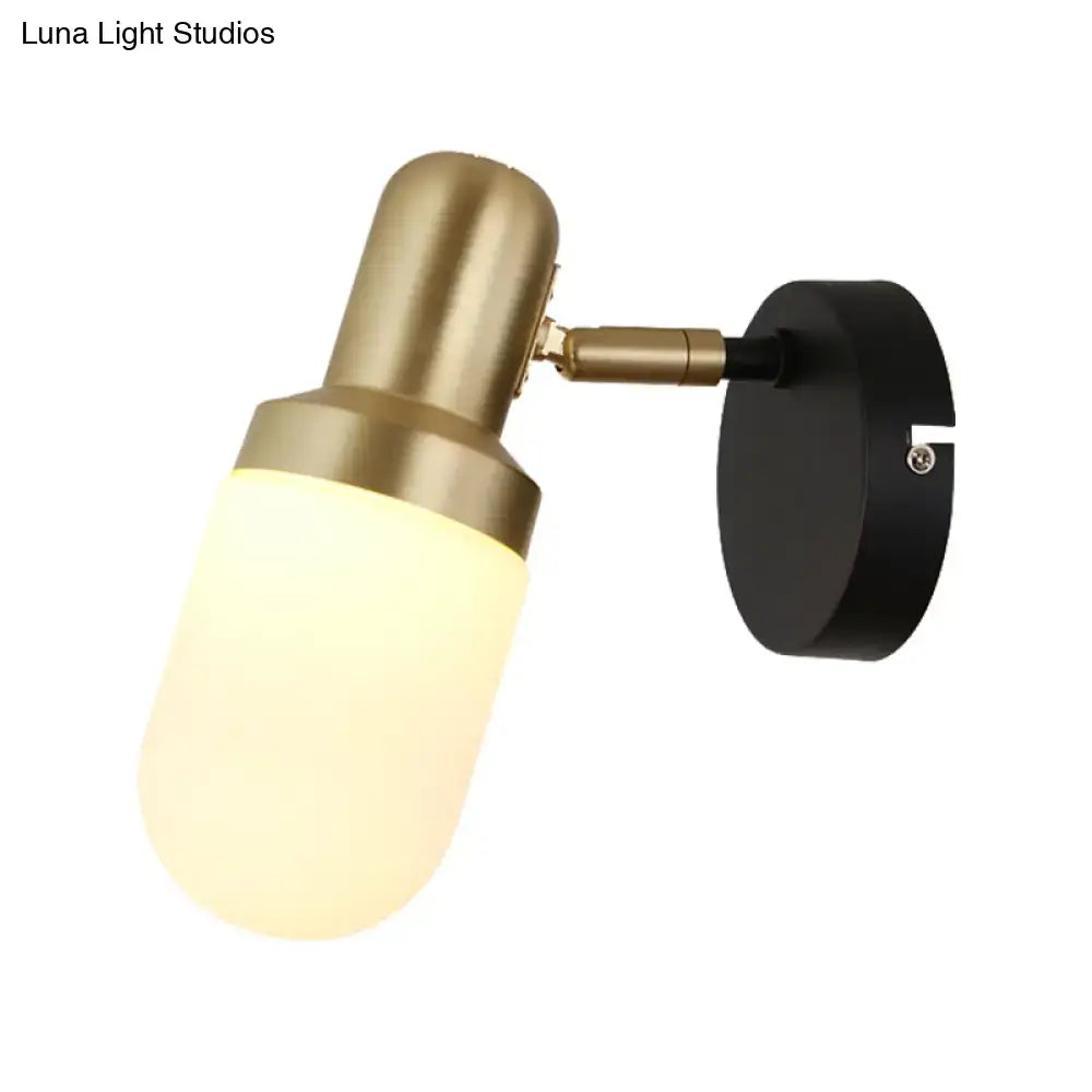 Modern brass and black glass sconce light with frosted glass shade and black mounting plate for bedroom wall use