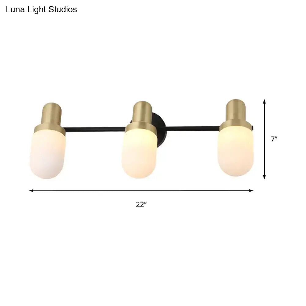 Modern brass and black glass sconce light with three frosted glass shades and brushed brass accents for bedroom wall lamp