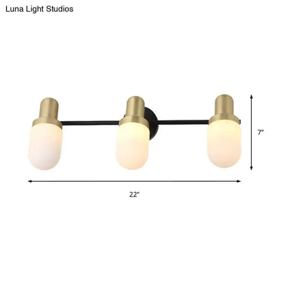 Modern brass and black glass sconce light with three frosted glass shades and brushed brass accents for bedroom wall lamp