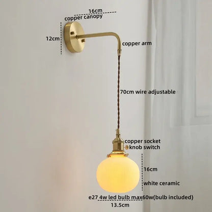 A warm glowing white ceramic globe wall lamp with brass copper arm and 70cm adjustable wire decorbites ceramic copper led