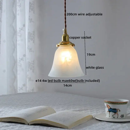 Modern brass and clear glass chandelier pendant light with a warm bell-shaped frosted glass shade for dining room