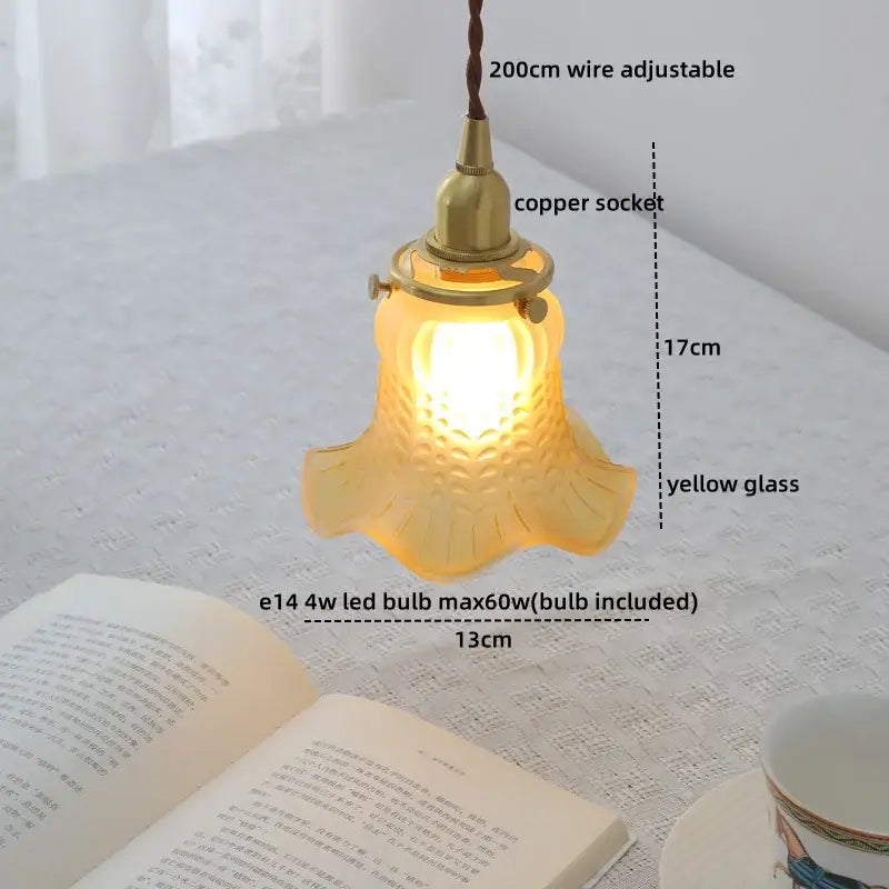 Modern brass and clear glass chandelier pendant light with warm yellow textured petal design for dining room